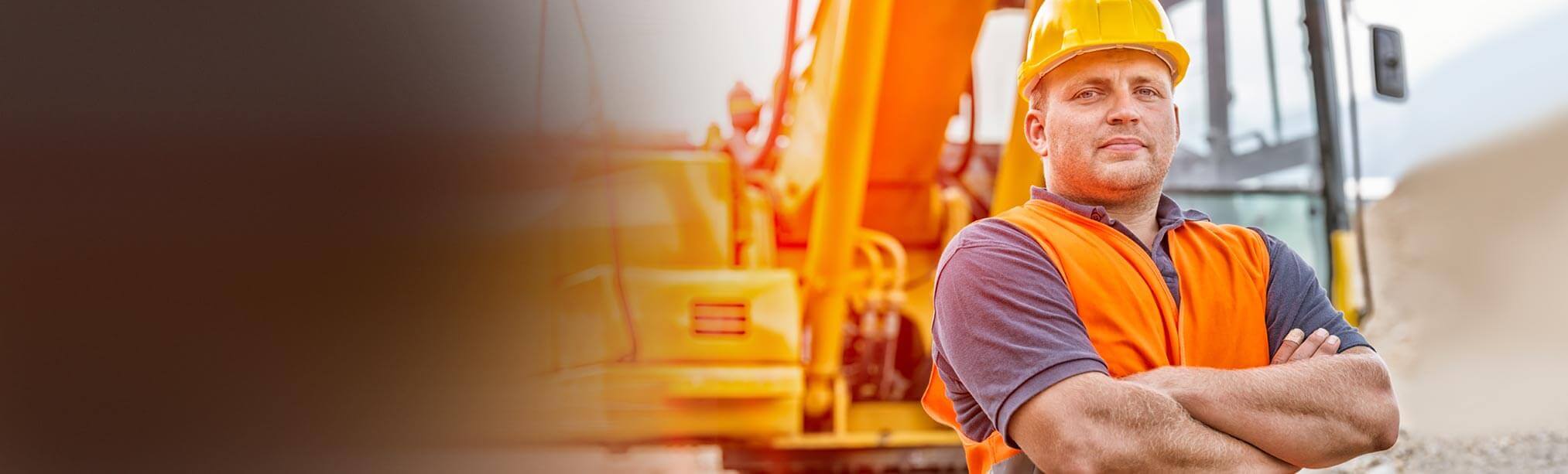 Construction worker with equipment in background